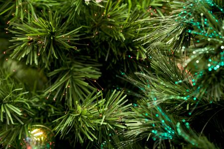 Close-up of artificial fir tree branches sparkling on endsの写真素材