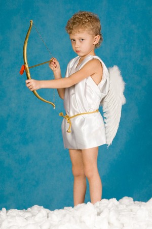 Portrait of young male angel holding bow の写真素材