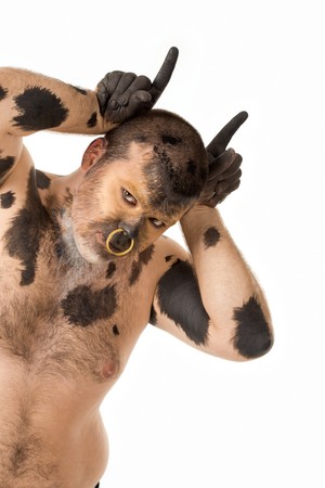 Portrait of man with body painting looking like bull over white backgroundの写真素材