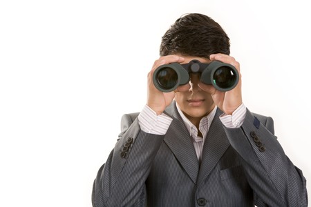 Portrait of confident man in suit observing through binoculars の写真素材