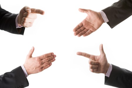 Conceptual collage of four hands in suit 