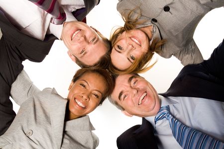 Below view of four partners looking at camera with their heads next to each otherの写真素材