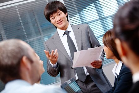 Photo of confident businessman making report to partners at seminarの写真素材