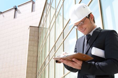 Portrait of confident foreman in helmet making business plan