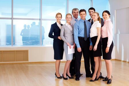 Portrait of confident business group standing next to each other and looking at camera の写真素材