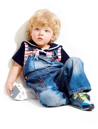 Portrait of pensive kid on white backgroundの写真素材