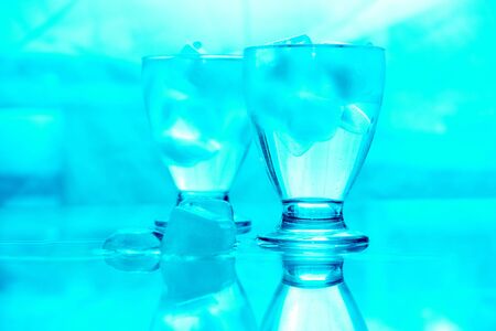 Blue image of two glasses of water with ice   の写真素材