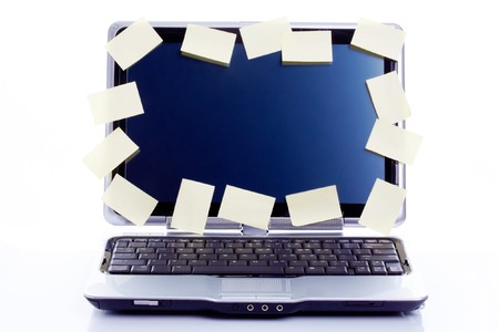 Image of laptop display stuck with blank note papers