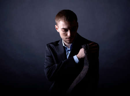 Portrait of serious businessman in darknessの写真素材