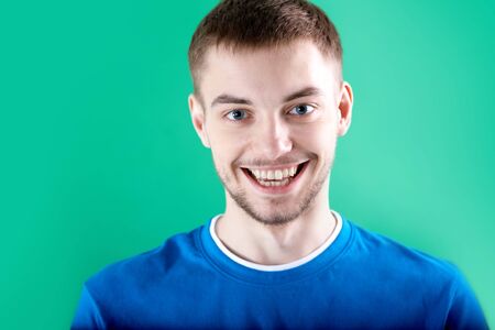 Portrait of young man looking at camera with smileの写真素材