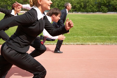 Image of active employees running down sport track の写真素材