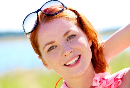 Portrait of young woman with red hair looking at camera の写真素材