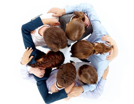 Above view of several business partners nodding heads and embracing each other standing in circleの写真素材