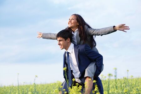 Portrait of happy business partners enjoying life and freedom in meadowの写真素材