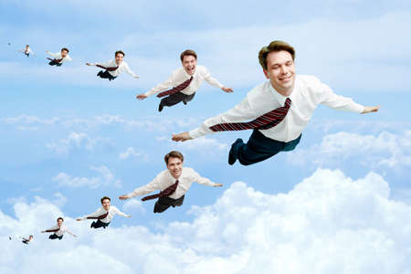 Conceptual image of many businessmen flying in the cloudsの写真素材