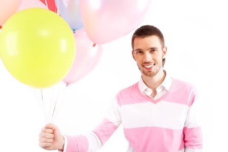 Image of attractive man with colorful balloons looking at cameraの写真素材