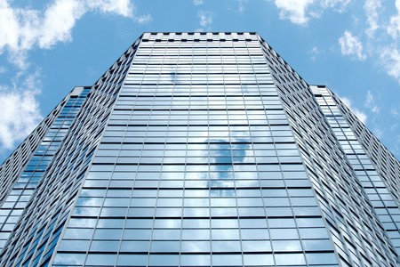 Image of modern office building against cloudy sky