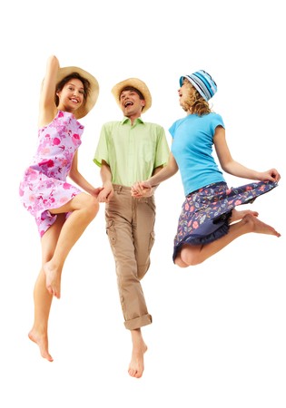 Portrait of joyful girls in jump holding happy man by hands in isolationの写真素材