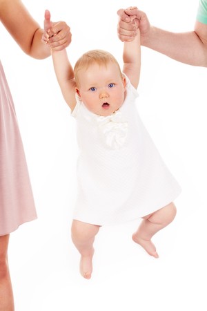 Portrait of small girl being held by her parentsの写真素材