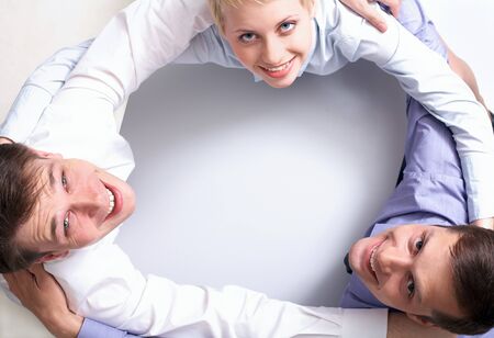 Photo of happy business partners embracing each other at workplace  の写真素材