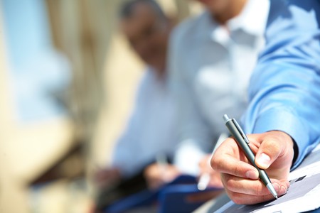 Male hand over paper making notes at seminar  の写真素材