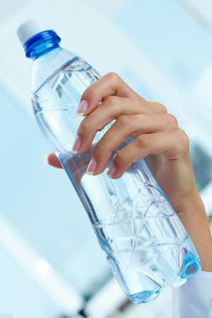 Image of plastic water bottle in female handの写真素材
