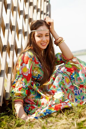 Portrait of pretty young lady in country clothing looking at camera outdoorsの写真素材