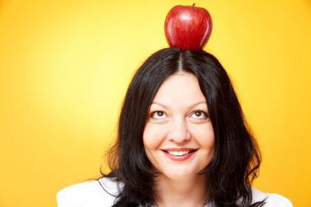 Portrait of middle-aged female looking at red on her headの写真素材