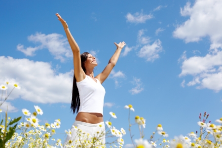 Image of happy female standing with raised arms on summer dayの写真素材