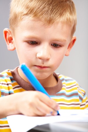 Close-up of school boy drawing picture  の写真素材