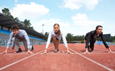 Row of business people getting ready for race on stadiumの写真素材