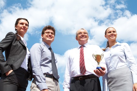 Portrait of confident business group on background of cloudy skyの写真素材