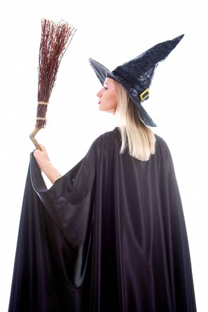 Portrait of young female in black hat and black clothing holding broomの写真素材