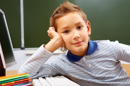 Portrait of smart lad at his place looking at cameraの写真素材