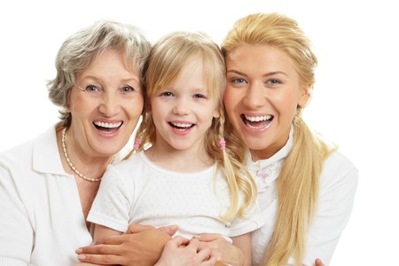 Portrait of grandmother with adult daughter and grandchild laughing 