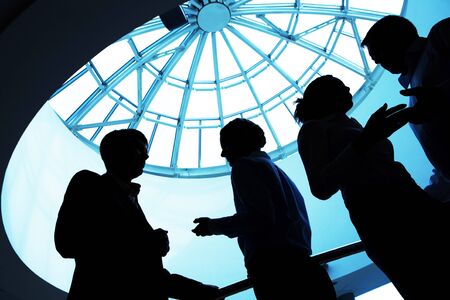Silhouette of business people interacting with each other  の写真素材