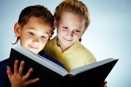 Image of smart children reading interesting bookの写真素材