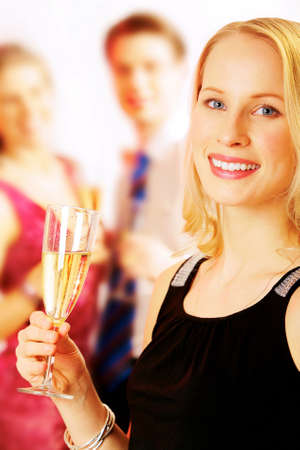 Portrait of beautiful lady with champagne on the background of peopleの写真素材
