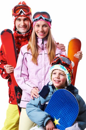 Portrait of happy family with snowboards looking at camera on white backgroundの写真素材
