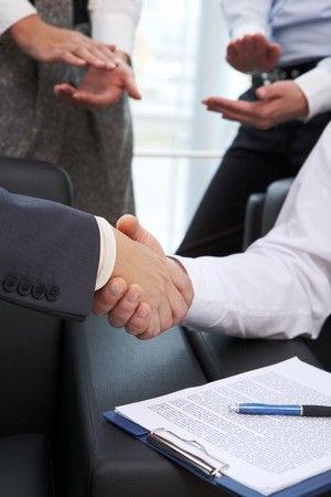 Image of business handshake after signing contractの写真素材