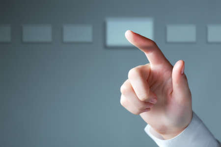 Image of businesswomanï¿½s hand with forefinger touching sensor screen  の写真素材