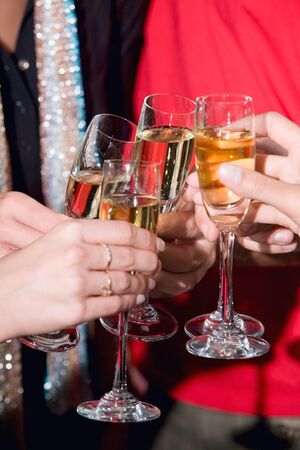 Image of human hands holding the glasses of champagne
