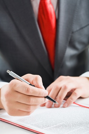 Close-up of a businessman's hand with a ballpointの写真素材