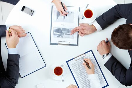 Image of business people hands working with papers at meeting