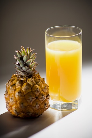 Pineapple and the glass of fresh juiceの写真素材