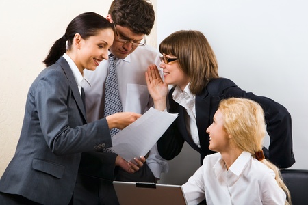Business team of three people discussing a new project in roomの写真素材