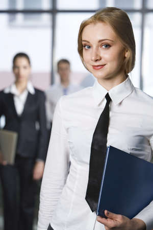 Portrait of young business woman looking at camera in a office