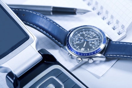 Creative photo: telephone, wrist-watch, notepad and fountain-penの写真素材