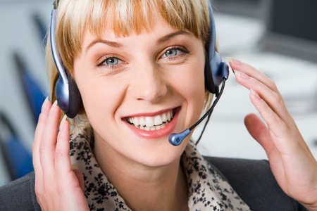 Pretty smiling Customer Support Representative with headsetの写真素材