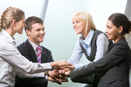 Business team putting their hands on top of each other
